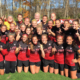 Photo shows players and coaches of Ball State's women's soccer team.
