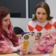 Two student, Anna McCreary and Trinity Czarnik gather in front of a laptop in the design studio.