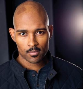 Evan Hoffmeyer stairs at the camera with a bright light behind his head.