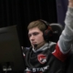 all State student wearing a headset raises arms in celebration while competing in an esports match.