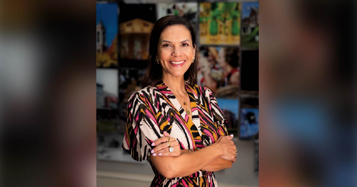 Ball State alumna Natalie Vega O’Neil, ’98, smiling with arms crossed, now president and CEO of Junior Achievement of Washington.