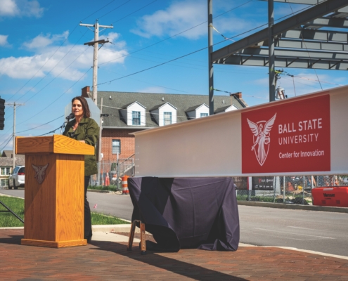 Jennifer Palilonis at podium during beam signing ceremony