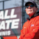 Bill Richards stands in front of tennis courts