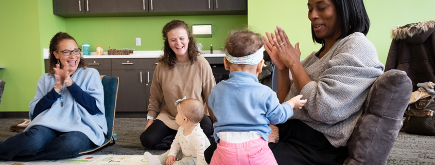 Parents and children attend a "Baby and Me" class