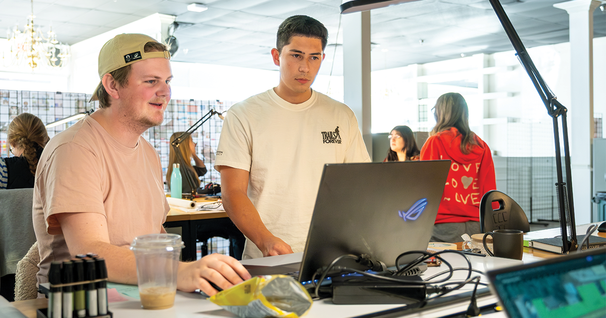Two students looking at computer screen