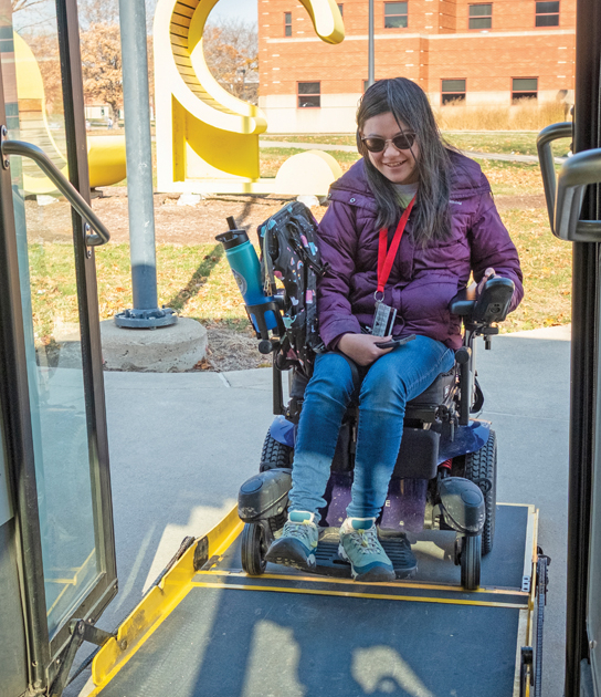 Amelia Stirm in her wheelchair getting on the bus