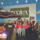 A large group poses for a photo holding banners reading "One Ball State Day""