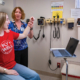 Doctor and patient in an exam room looking at the patients shoulder