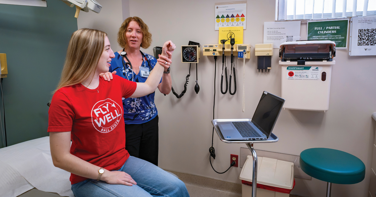 Doctor and patient in an exam room looking at the patients shoulder