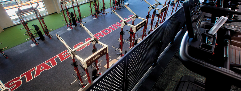Ball State Cardinals strength and conditioning facility with weight racks, training equipment, and treadmills.