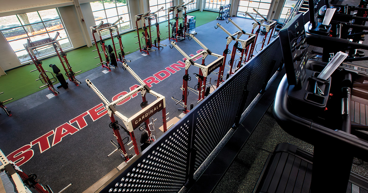 Ball State Cardinals strength and conditioning facility with weight racks, training equipment, and treadmills.