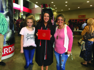 Little Buddy Layna and her mom supported Lexi Evers, ’17, at graduation.