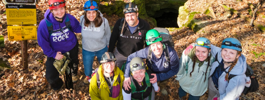 A group photo of several people wearing hiking gear.