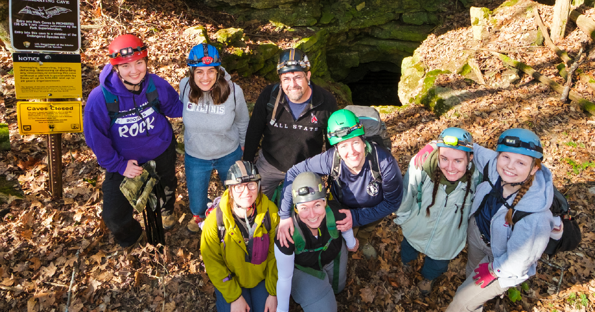 A group photo of several people wearing hiking gear.
